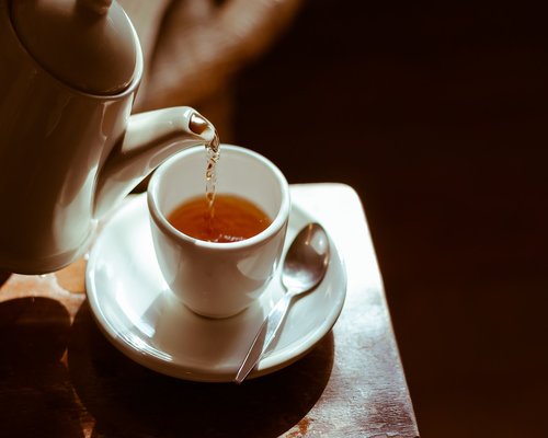 Woman drinking herbal tea in a cozy room