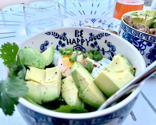 Healthy salad bowl with avocado and greens